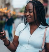cheerful-african-american-woman-using-smartphone-2025-04-01-13-04-45-utc cheerful-african-american-woman-using-smartphone-2025-04-01-13-04-45-utc