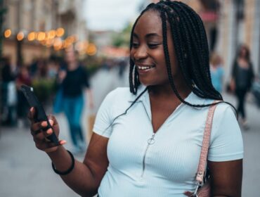 cheerful-african-american-woman-using-smartphone-2025-04-01-13-04-45-utc