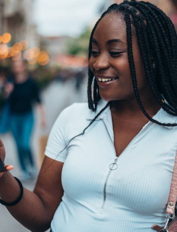 cheerful-african-american-woman-using-smartphone-2025-04-01-13-04-45-utc